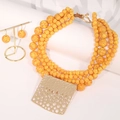 Detailed macro of bohemian beaded necklace set with hammer textured gold pendant - Bright Yellow Multi-layer Necklace & Earrings Set - Square Pendant (X-1018)