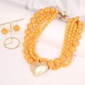 Detail of bohemian multilayer orange beaded necklace with hammered gold heart pendant - Bright Yellow Multi-layer Necklace & Earrings Set - Heart Pendant (X-1018)