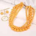 Detail of multi-layered yellow beaded necklace and earrings on minimalist white display stand - Bright Yellow Multi-layer Necklace & Earrings Set - No Pendant (X-1018)