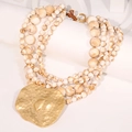 Detail of layered bohemian beaded necklace with large gold hammered metal pendant - Irregular Hammered Multi-layer Necklace