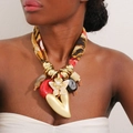 Detailed view of bohemian fabric necklace with leopard print and large golden heart pendant - Orange Yellow Leopard Print