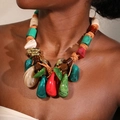 Close-up of bohemian woven rope necklace with colorful resin beads and teardrop pendant - Multicolor