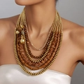Bohemian multi-layer necklace with acrylic beads and gold teardrop pendants on model - Brown