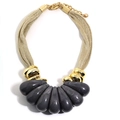 Close-up of golden mesh necklace with grey teardrop marble pendants and lobster clasp - Gray