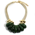 Close-up of gold mesh chain and dark green teardrop pendants on a statement necklace - Green