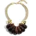 Detailed close-up of dark brown marble resin teardrop pendants on golden mesh chain - Brown