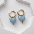 Détail des breloques cœur en résine avec motif marbré sur des boucles d'oreilles dorées - Bleu Ciel