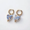 Macro detail of heart-shaped ceramic earring with hand-painted floral patterns and 18K gold hoop - Blue Outline Floral Style (DE203-G)