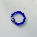 Elastic blue bead ring with evil eye charm and gold-toned spacers for women - Blue