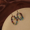 Detail of bohemian handmade colorful beaded hoop earrings on a stone display base - Bohemian Multi-layer Seed Bead Earrings (DE033)