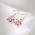 Pink cat eye stone flower earrings with gold hooks on white fabric background - Pink Cat's Eye Flower