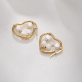 Close-up of heart-shaped gold earrings with wrapped pearls on white silk - Heart Wire Wrapped Pearl Style (E038-D) / Gold