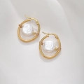 Macro detail of gold hoop earrings with white baroque pearls on white silk background - Oval Pearl Style (E038-A) / Gold