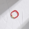 Macro detail of red square crystal beads ring with a polished golden heart charm - Red Square Bead Heart Pendant (DR003-E)