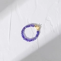 Macro detail of elastic purple crystal beaded ring with a gold crown charm pendant - Purple Square Bead Crown Pendant (DR003-B)