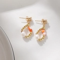 Macro shot of gold teardrop earrings with freshwater pearls and orange gemstones on linen - Waterdrop Orange Beaded Style (DE045-A)