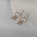 14K gold plated hoop earrings with vintage pine cone pendants on minimalist background - Patterned Rice Bead Style