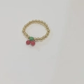 Elastic beaded flower ring with red cherry charms and gold beads on white background - Gold Bead Cherry