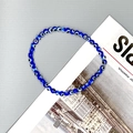 Detail of blue evil eye beaded stretch bracelet showing glass texture and elastic cord - Blue