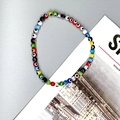Detailed view of colorful evil eye beaded elastic bracelet with glass eye charms - Colorful