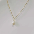 Detailed close-up of 14K gold plated titanium necklace with white teardrop pearl pendant - Threaded Pearl Style