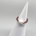 Detail of a handmade stretch ring with white freshwater pearls and red faceted glass beads - Adult Size / Red