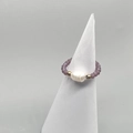 Detailed shot of handmade elastic ring with baroque pearl and purple crystal beads - Purple