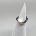 Detail of beaded stretch ring with blue faceted stones and a large baroque pearl center - Navy Blue