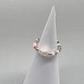Macro detail of elastic beaded ring featuring a large baroque pearl and colorful glass beads - Rainbow