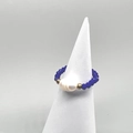 Detail of handmade elastic ring with blue faceted beads and a white baroque pearl focal - Blue