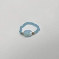 Macro detail of sky blue beaded elastic ring with gold spacers and blue faceted oval stone - Child-Inner Diameter 13-14mm / Lake Blue-Gold