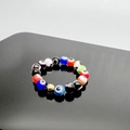 Macro shot of colorful beaded evil eye elastic rings with vibrant resin charms and gold accents - Colorful-Gold Accessories / One Size 17mm