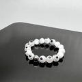 Macro detail of elastic beaded ring featuring evil eye charms and silver metal spacer bead - One Size 17mm