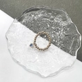 Macro detail of elastic beaded ring with heart-shaped blue zircon charm in gold finish - Gold-Light Blue Zircon