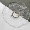 Elastic gold bead ring with purple heart-shaped pendant on glass tray display - Gold - Purple Zirconia