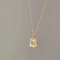 Detail of square gold butterfly necklace with white mother-of-pearl inlay and bead chain - Butterfly Mother of Pearl Style (SN093)