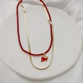 Close-up of double-layered necklace with red beads and golden elephant charm - Red