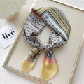 Silk-feel square scarf with yellow and pink geometric floral pattern displayed on wood - Gem Flower Frame Yellow (1)