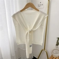 White knitted shoulder wrap with cashmere fabric tie-knot design on a wooden hanger - White