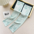 Detail of mint green tie-dye cooling ice silk sun protection sleeves with ribbed texture - 9D Tie Dye Green
