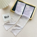 Detail of lavender gradient cooling arm sleeves on a minimalist aesthetic display tray - 10D Purple Beige Tie Dye