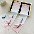 Detail of pink gradient cooling sun sleeves with Doria Dore logo on a white background - One Size / Gradient Pink