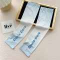 Detail of gradient ice silk cooling sleeves with blue Doria Dore lettering and knit texture - One Size / Gradient Blue