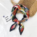 Colorful pleated silk scarf with abstract patterns shown on a white textured background - Colorful Cat