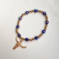 Detail of beaded bracelet featuring gold spheres, purple faceted beads and bull head charm - Blue