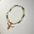 Detailed close-up of golden longhorn skull charm on a crystal beaded stretch bracelet - Champagne