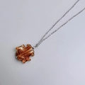 Detailed view of bohemian amber glass pendant with golden glitter and silver chain - Steel-Amber