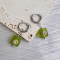 Detail of square green resin earrings with pink floral patterns on stone surface - Green-Steel Color