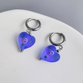 Macro detail of frosted blue glass heart earring with purple spiral texture and silver hoop - Blue Heart-Steel