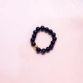 Elastic ring featuring natural black marble beads and a single golden metal bead accent - Black Crack - Gold Color